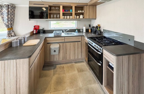 Castle Douglas House | 12ft-wide caravan situated in a coastal position.