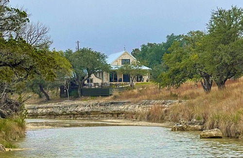 Johnson City House | 2 bedroom/2 bath stone farmhouse overlooking hill country creek on 50 acres
