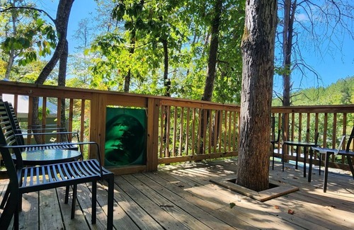 Mill Spring Cabin | 2-story treehouse with a cargo net connecting the upstairs lofts, a large balcony with a slide to the ground level, sleeps 10.