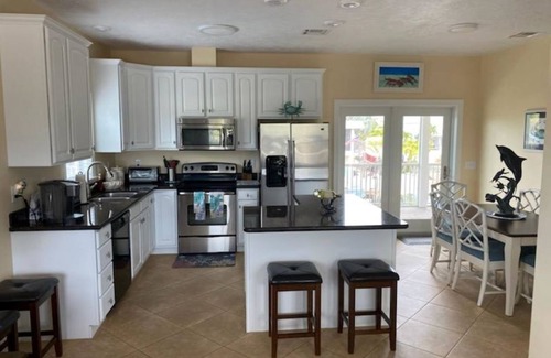 Breezeswept Beach Estates House | 3/2 two story home with pool and 80' dock on canal ocean side.