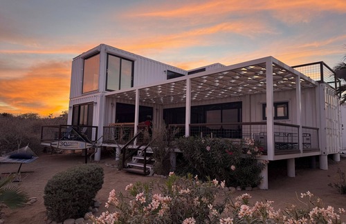 El Sargento House | 3 bedroom, 3 bath premium repurposed shipping container home. Game room w/darts, shuffleboard, video games, new 8 person hot tub, multiple decks w/firepits, fast Wifi (250 mb+)w/Starlink backup. Use of SUPs & beach chairs/shade/games.