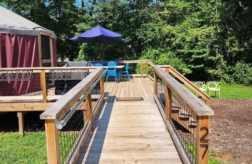 Mill Spring House | 30' ADA Yurt with a large deck, on the creek, full kitchen, dome skylight, dog friendly, 2 bedrooms, sleeps 5.