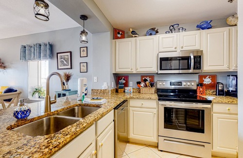 Waterside Village Condo | 4th-floor canal view condo with balcony, pool/hot tub access, washer/dryer & AC