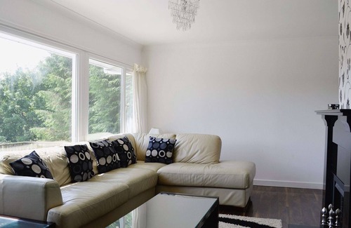 Tighnabruaich Cottage | A detached wooden bungalow, on an open elevated position facing east out to the Kyles of Bute.