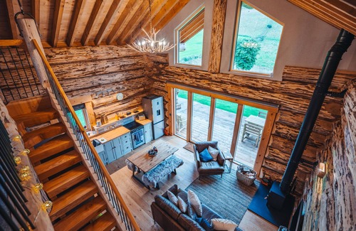 Melrose Cabin | A fairy tale log cabin hand crafted from huge Douglas Fir trees. This rustic luxury cabin has oodles