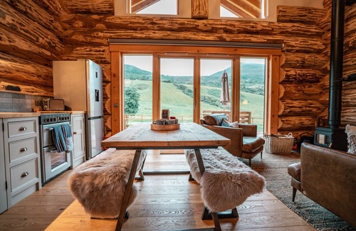 Melrose Cabin | A fairy tale log cabin hand crafted from huge Douglas Fir trees. This rustic luxury cabin has oodles