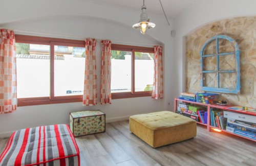 El Vendrell House | A large cottage with bright interior and private outdoor pool, next to a covered terrace.