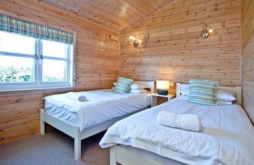 St Merryn Cabin | A light and spacious lodge with one double with walk in wardrobe and en-suite shower and one twin.