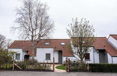 Nieuwpoort House | 'A little white house with a tree by the sea' with beach cabin by BLOSS