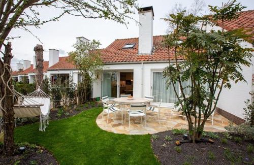 Nieuwpoort House | 'A little white house with a tree by the sea' with beach cabin by BLOSS