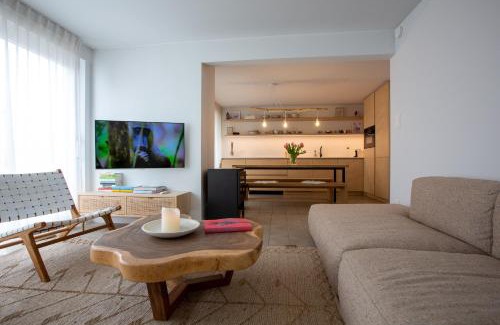 Nieuwpoort House | 'A little white house with a tree by the sea' with beach cabin by BLOSS
