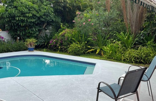 Central Beach House | A tropical retro bungalow secluded area with terrazzo flooring & heated pool.