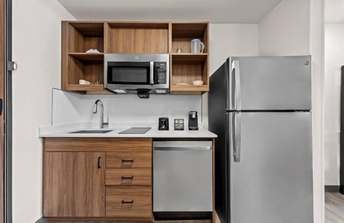 Brownsville Hotel | Accommodates 3 Suites | King Bed + Kitchen & Sofa