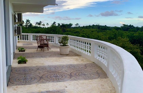 Cabrera Hotel | Adorable tropical room with a stunning balcony, pool, fire pit, gardens, & more!