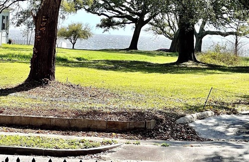 Gulfport House | After beach time come back to an outdoor soaking tub in privacy fenced back yard