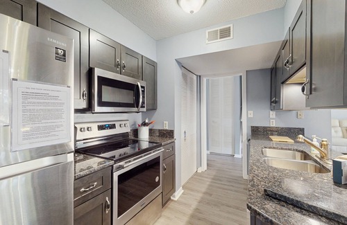 Little River House | All-suite Bay Tree retreat with al fresco dining, water views, and shared pool