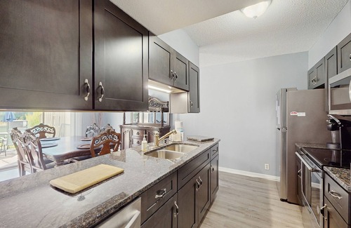 Little River House | All-suite Bay Tree retreat with al fresco dining, water views, and shared pool