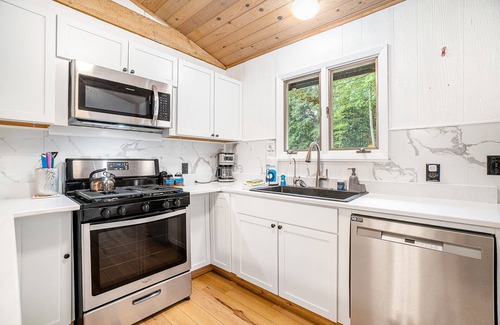 Lake Township House | Amazing riverfront retreat with firepit, patio, W/D, & great views