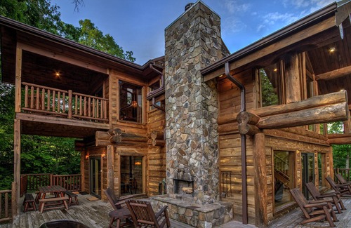 Almond Cabin | Antler Ridge - a stunning log cabin with spacious deck equipped with outdoor fireplace, hot tub, and scenic mountain views!