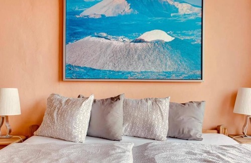 Teguise Resort | Apartment 1 with panoramic window in the bedroom facing the sea and Risco Famara