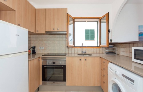 Arenal d'en Castell Apartment | Apartment 'En Arenal En Castell' with Sea View, Shared Pool and Wi-Fi