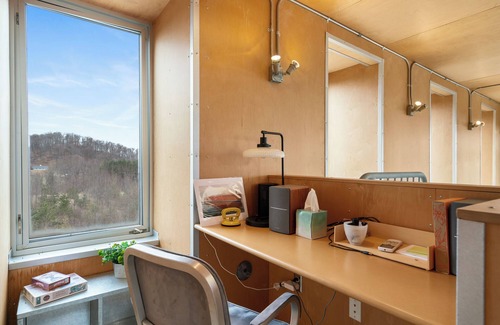 Northport House | Award-winning 9-level Chameleon House in Leelanau County. A modern-industrial masterpiece with reflective siding, rooftop deck, and epic Lake Michigan views near beaches and Fishtown.