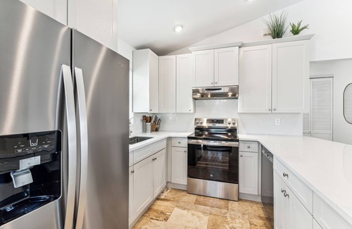 Mid Island House | Beachside Retreat: 2BD/2.5BA + Jet Ski Lifts + Epic Game Room & SHARED Pool!
