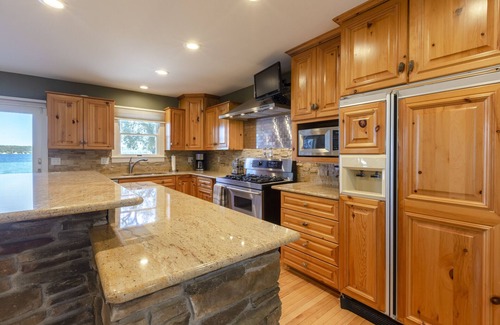 Suttons Bay House | Beautiful Beach Front on Suttons Bay with Sunset Views.