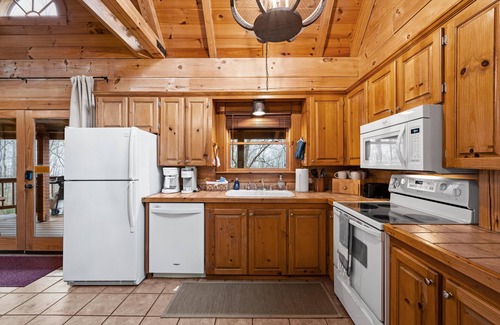 Gatlinburg - Pigeon Forge Cabin | Beautiful cabin nestled among the trees, featuring a loft and relaxing hot tub.