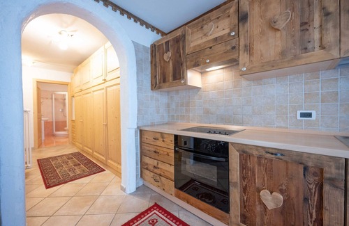 Campitello di Fassa Apartment | Beautiful mountain refuge style apartment with aged wood finishes