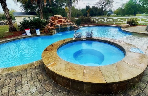 Alvin House | Beautiful Vacation Home ,Tropical Resort Pool with Waterfall and Heated Hot tub.