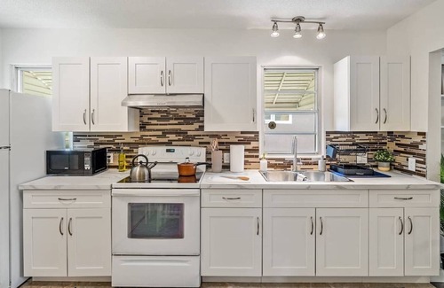 Southwest Edmonton House | Big, fun-filled stay steps from Whyte Ave with yard, games, and coffee bar