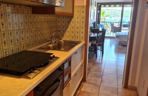 Porto Azzurro Apartment | Blue harbor lovely apartment with terrace above the beach.