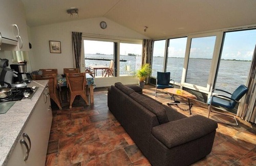 Oudega House | Boat "De Frijheit" overlooking the water