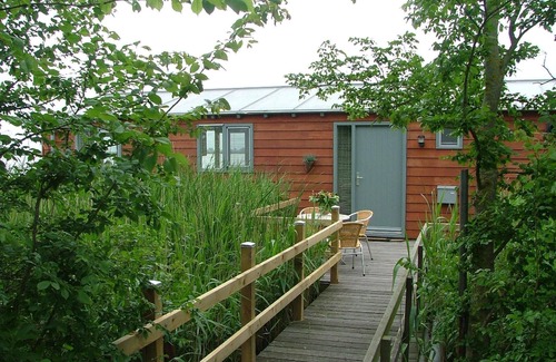 Oudega House | Boat "De Frijheit" overlooking the water