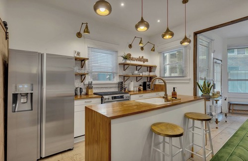 Midtown Apartment | Boho-style 2BR/2BA Midtown triplex with private front patio. King + queen bedrooms, updated kitchen, smart TVs, self check-in, and laundry. Walk to Piedmont Park, Trader Joe’s, and restaurants. Free street parking. No pets.