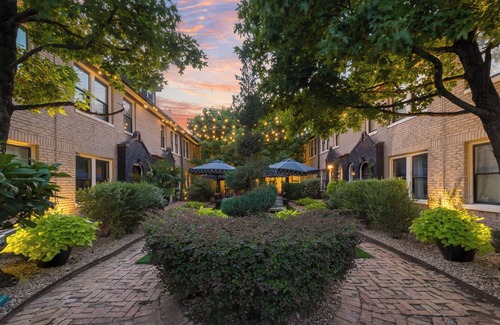 Old East Dallas Condo | Bright and luxurious 1-bedroom condo combining historic charm with modern comfort. Features a spacious living area with elegant furnishings, crystal lighting, and abundant natural light for a refined Dallas stay.