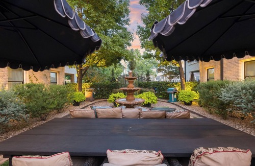 Old East Dallas Condo | Bright and luxurious 1-bedroom condo combining historic charm with modern comfort. Features a spacious living area with elegant furnishings, crystal lighting, and abundant natural light for a refined Dallas stay.