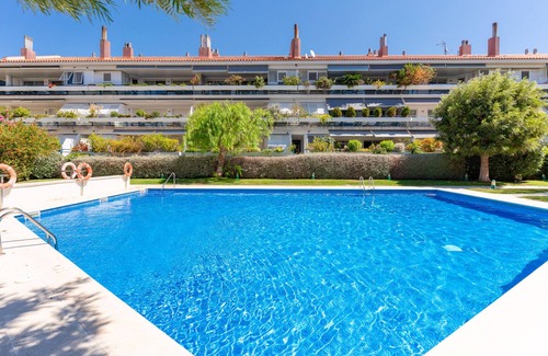 Passeig Maritim Apartment | Bright & Colourful Apt in Luxury Complex by Sea