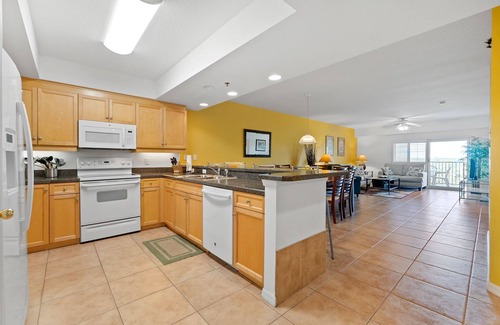 New Smyrna Beach Condo | Build family memories at this 3BR condo in New Smyrna Beach, just steps across the street from the sand. Enjoy a pool & spa outside your door, a luxe master bath, spacious bedrooms, and resort-style amenities in a gated community.