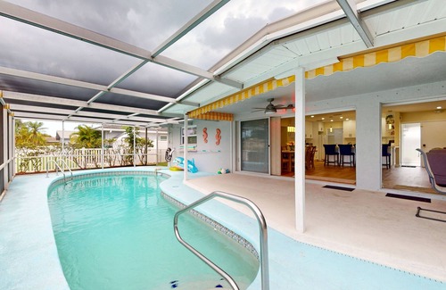 Clearwater House | Canal-front home with private pool, dock, grill, canal views, & W/D