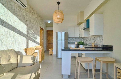 Quisqueya Apartment | Caribbean Sunset Soak Apt.In the center of town, steps from the Juan Dolio Beach