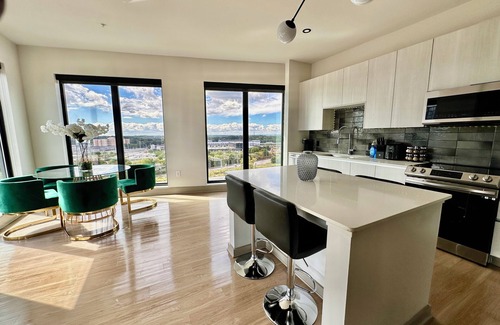 Westside Apartment | Ceiling to floor windows featuring a private balcony with stunning city views! n