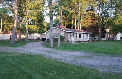 Prudenville Cottage | Centrally located, four season retreat w/firepit and lakeview.