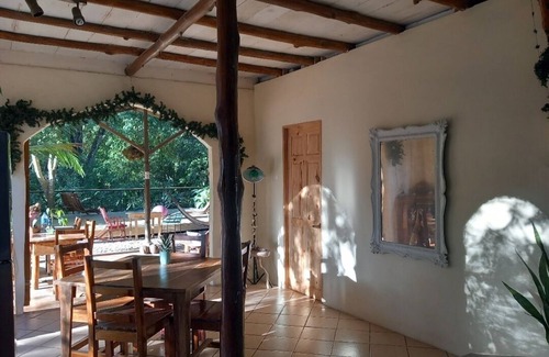 Buenos Aires Ski Chalet | Chalet with jungle view deck on a river in lively Santa Teresa's surf town
