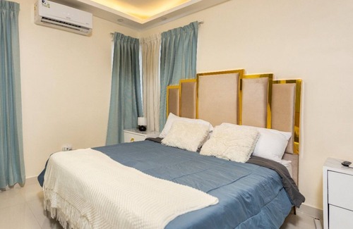 Prado Oriental House | Charming 2-bedroom building in Tranquil Santo Domingo Este with AC