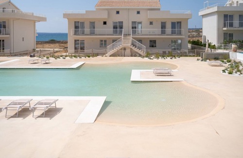 Pachino Apartment | Charming 40 sqm seaview apartment, able to accommodate up to 4 people, located inside the renowned Borgo 84 residence, equipped with swimming pool and cycle path. The property is located just 3 km from the center of Marzamemi, one of the most fascinating