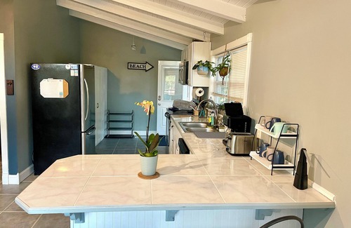 Butler Beach House | Charming Canal Front Cottage! Walk to the Beach!