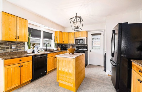 Petoskey House | Charming home with large backyard, firepit, grill, patio, and private W/D