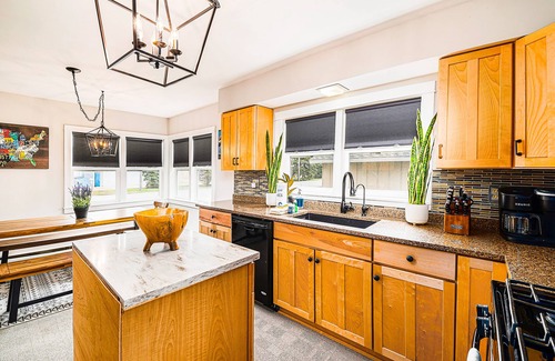 Petoskey House | Charming home with large backyard, firepit, grill, patio, and private W/D